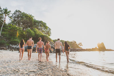 People at beach against sky