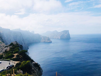 Scenic view of sea and mountains against sky