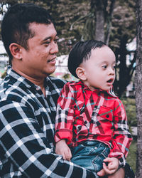 Boy looking at mother and daughter