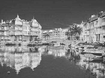 Boats in canal along buildings