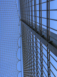 Low angle view of fence against sky