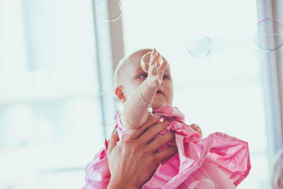 Baby chasing bubbles