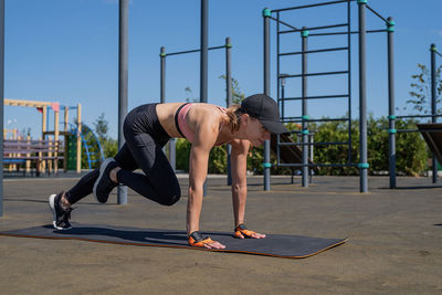 Full length of woman exercising in gym