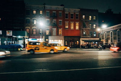Cars on city street at night