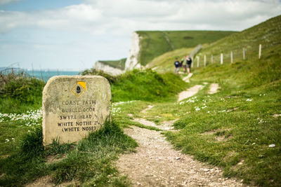 Sign on grassy cliff