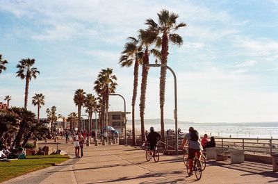 People at beach against sky