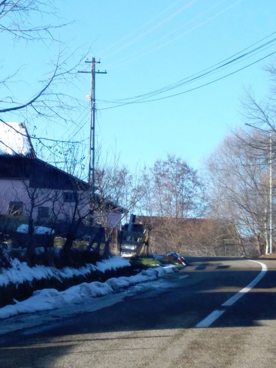 CAR ON ROAD AGAINST SKY