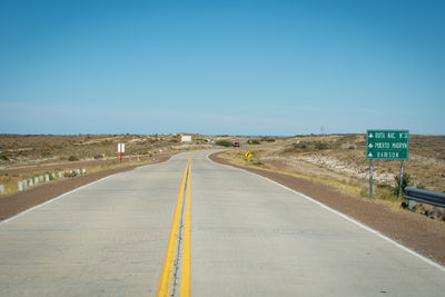 Road sign against clear sky