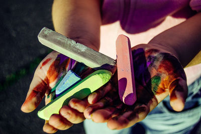 Close-up of woman's hands holding chalk