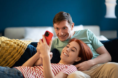Man and woman watching video on smartphone. rest, relax, good pleasant quality comfortable pastime