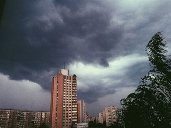 Buildings against cloudy sky