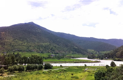 Scenic view of landscape and mountains against sky