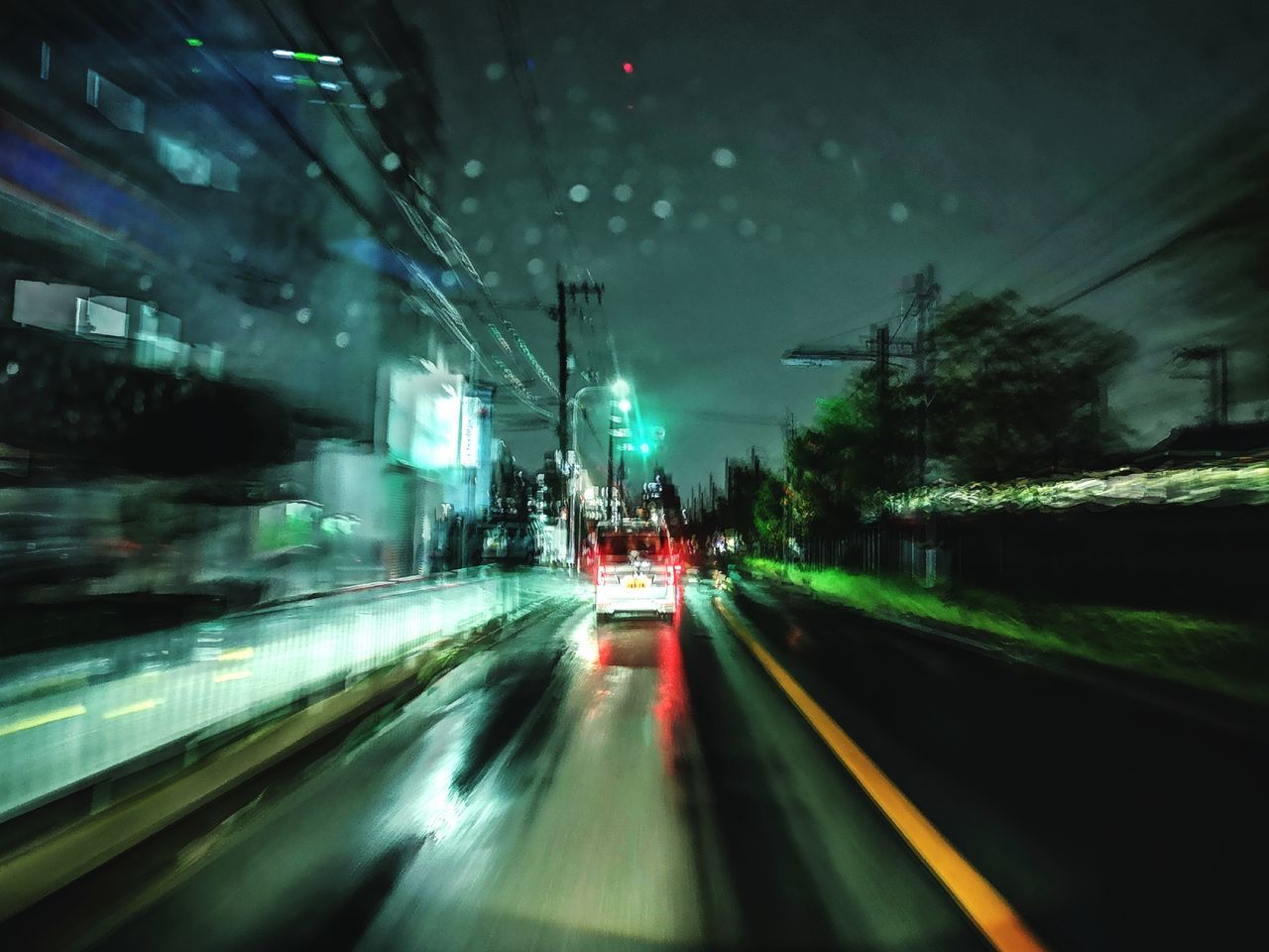 BLURRED MOTION OF VEHICLES ON ROAD IN CITY
