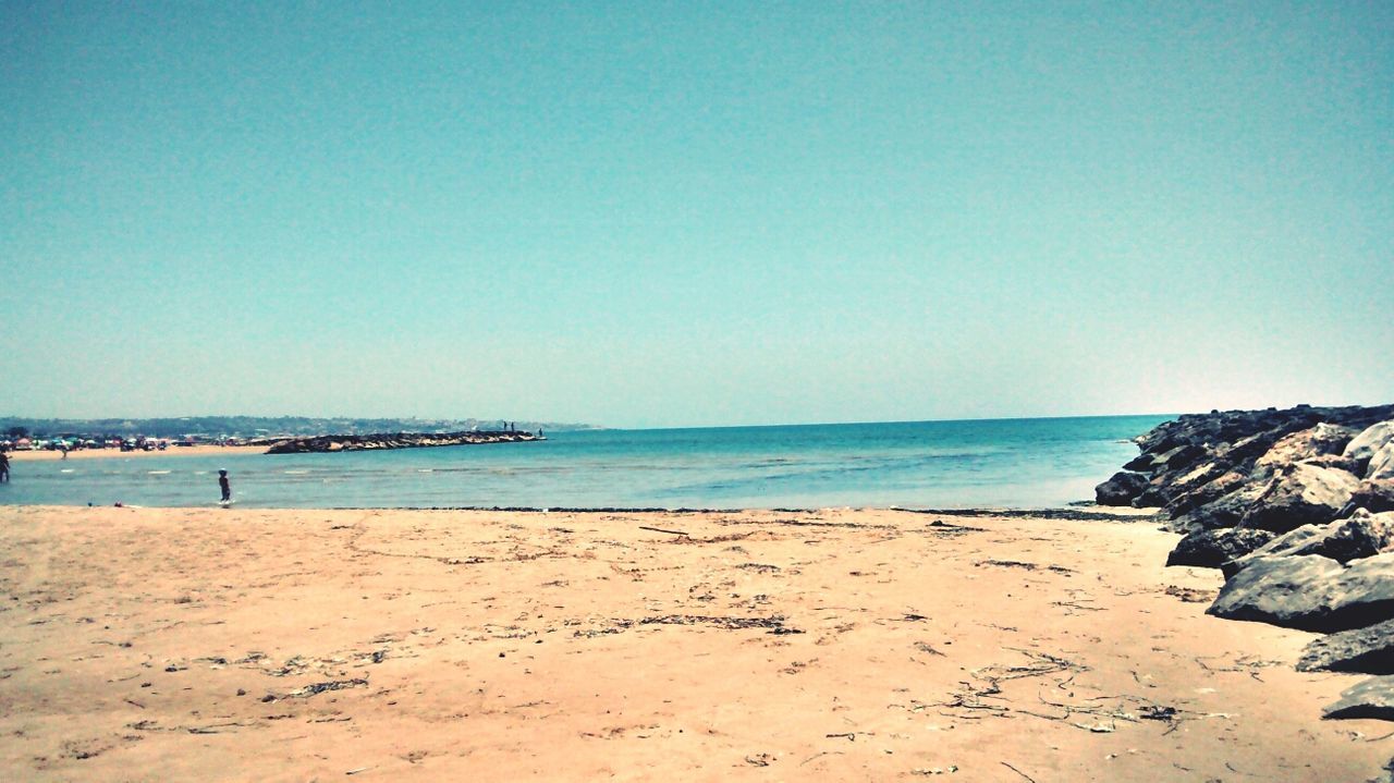 sea, beach, horizon over water, water, clear sky, copy space, shore, tranquil scene, sand, tranquility, scenics, blue, beauty in nature, nature, coastline, idyllic, calm, outdoors, remote, incidental people