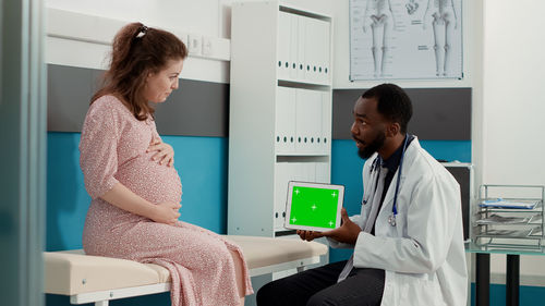 Doctor examining pregnant woman at medical clinic