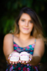 Portrait of a smiling young woman holding ice cream