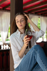 Portrait of woman holding wineglass