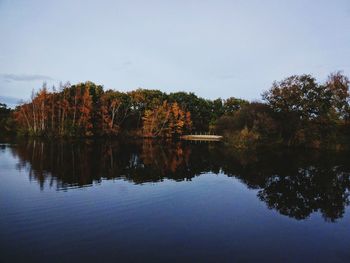 Reflection of trees in lake against sky