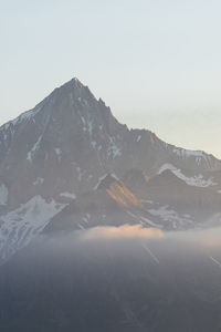 Scenic view of snowcapped mountains against clear sky