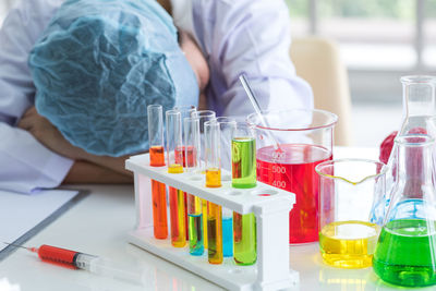 Scientist resting by chemical in laboratory