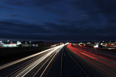 Light trails on road in city at night