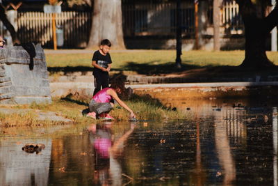 Reflection of boy running in water