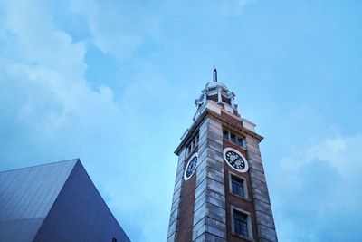 Low angle view of clock tower against blue sky