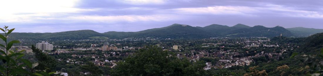 Panoramic view of townscape and mountains against sky