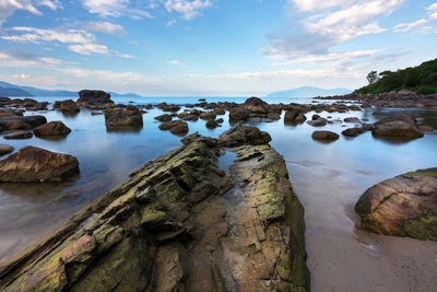 Rocks on shore against sky