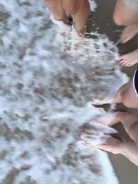 Low section of people standing in water