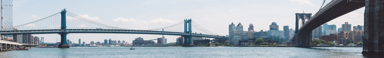 View of suspension bridge with city in background