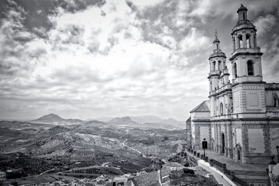 High angle view of buildings against cloudy sky