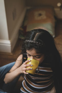 Cute girl drinking milk at home