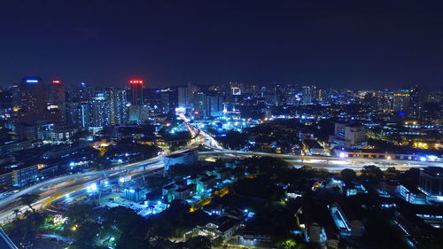 Illuminated cityscape against sky at night