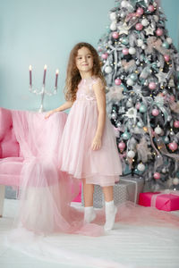 Portrait of smiling young woman sitting on stage