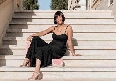 Portrait of woman sitting on staircase