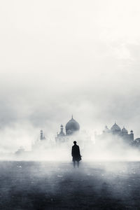 People in front of historic building against sky