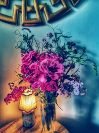 Close-up of pink flowers on table against wall