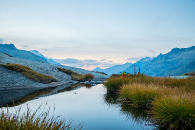 Scenic view of lake and mountains against sky