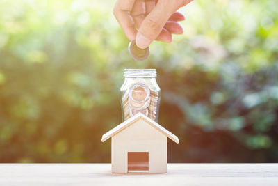 Human hand holding jar against blurred background