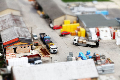 Tilt-shift image of trucks at factory