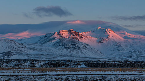 Full frame view of sunset lighting on snow covered volcanic mountain