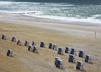 High angle view of hooded beach chairs