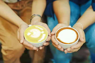 Close-up of hand holding coffee cup