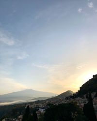 Scenic view of town against sky during sunset