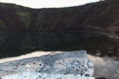 Close-up of rocks against mountain in winter