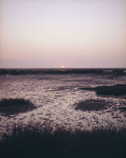 Scenic view of sea against clear sky during sunset