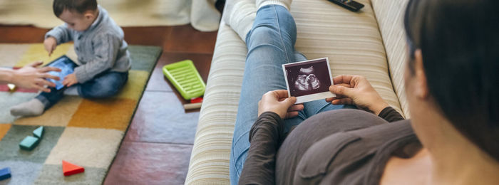 Midsection of woman using mobile phone