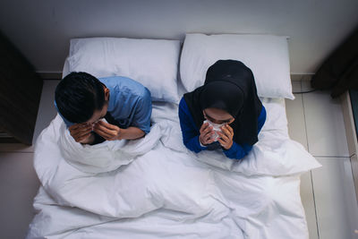 Friends sleeping on bed