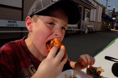 Boy eating meat in restaurant